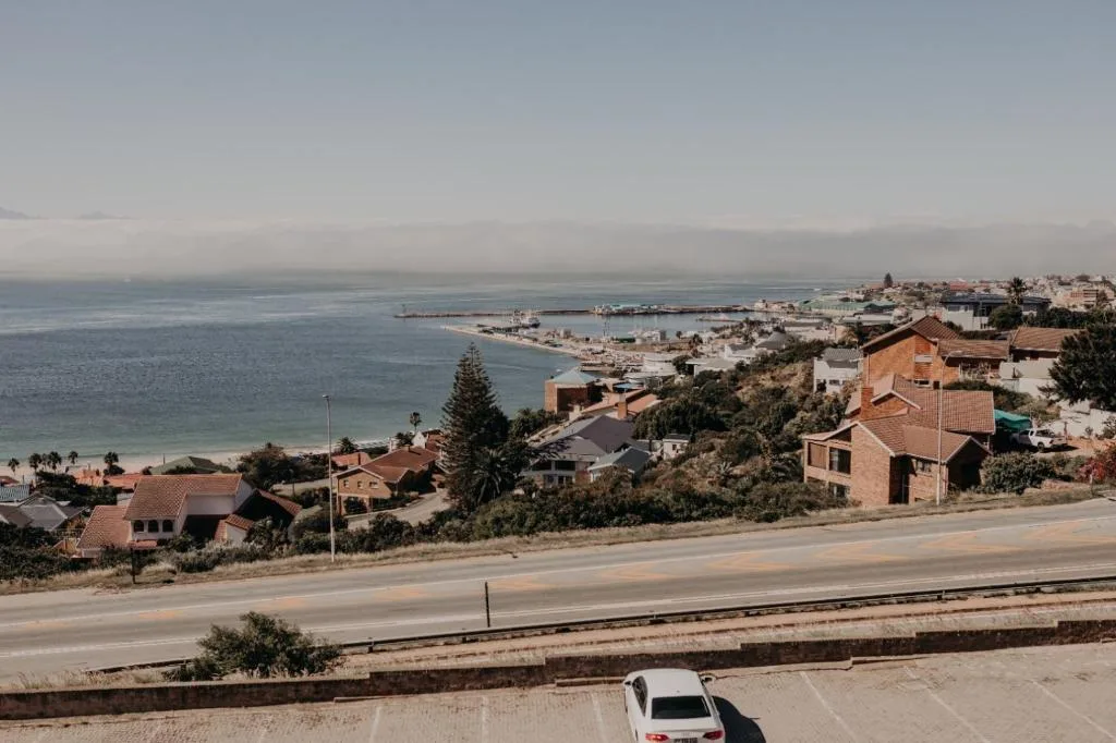 Scenic coastal view of Mossel Bay with lagoon, town buildings, and beach
