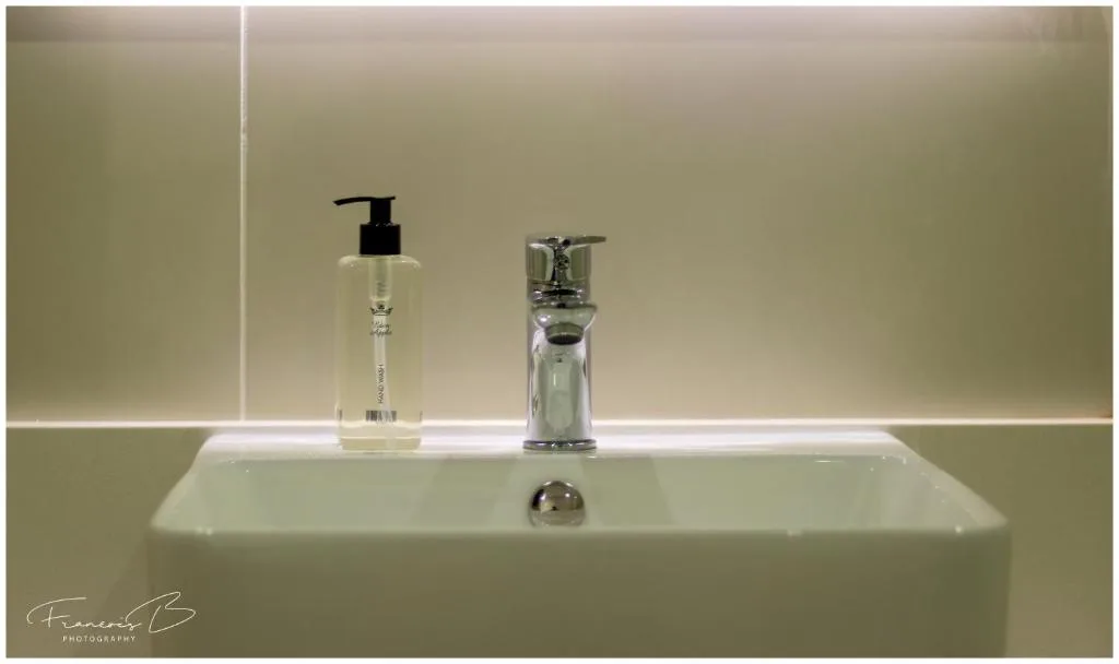 Modern bathroom sink with soap dispenser and chrome faucet fixtures
