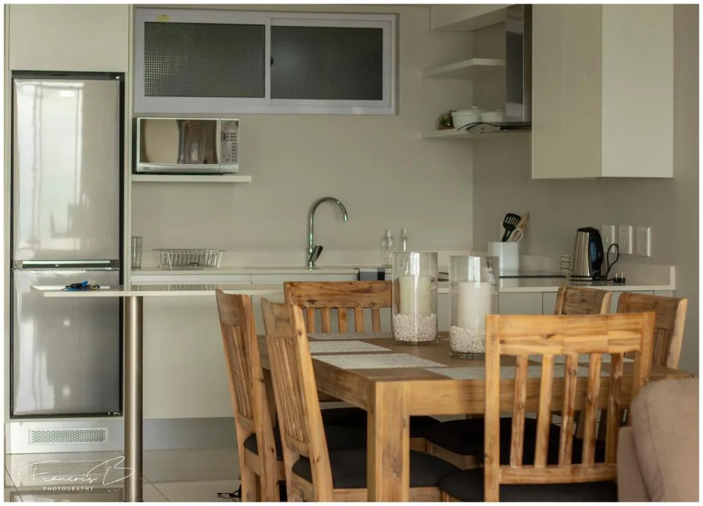Modern kitchen with stainless steel appliances and dining table