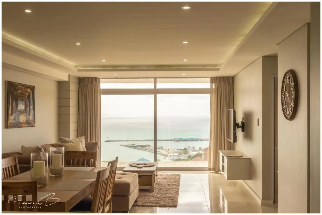 Expansive coastal lagoon and bay view framed by large windows from apartment
