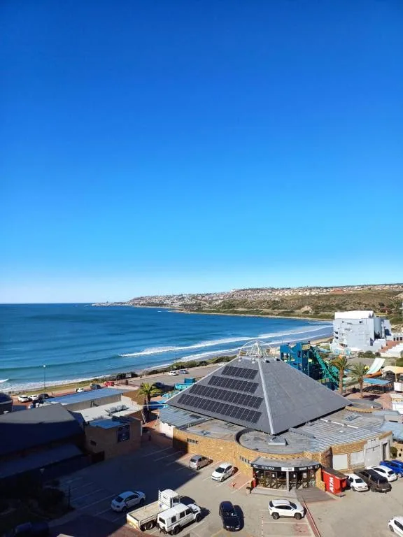 Sweeping ocean vista with beach and coastal town landscape below