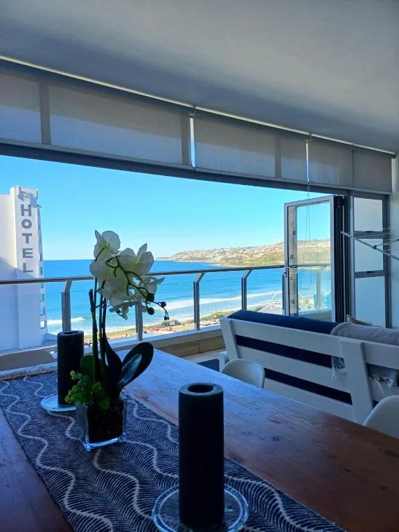 Panoramic ocean and coastal landscape view from modern apartment balcony