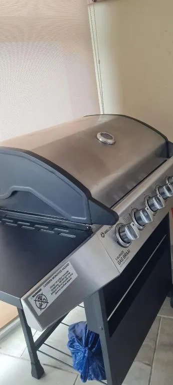 Built-in braai grill with stainless steel hood and control knobs